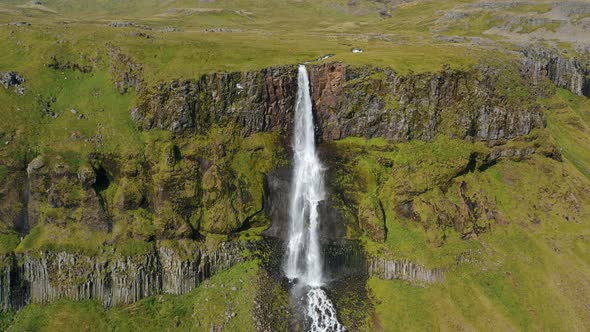 Aerial Drone Footage of Bjarnarfoss Waterfall with Its Green Cliffs in Western Iceland