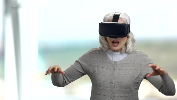 Old Woman Wearing Virtual Reality Headset.