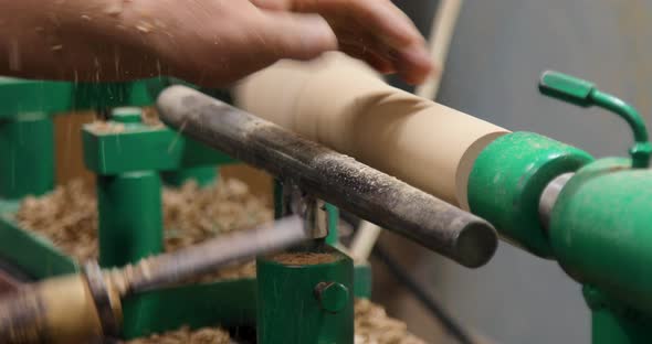 Closeup of carpenter turning wood on a lathe