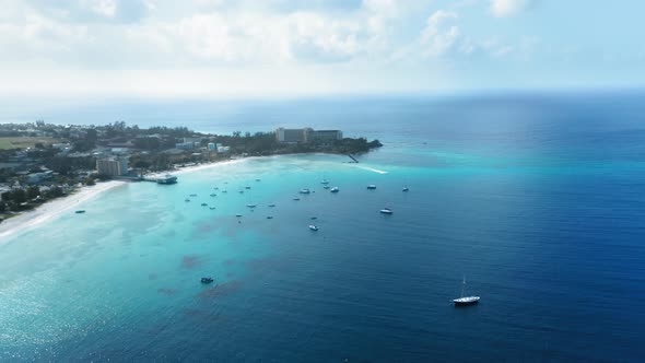 Drone shoots as a boat cuts through the sea among yacht near Bridgetown, Barbados