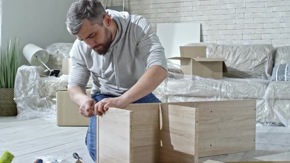 Man Building Wooden Shelf