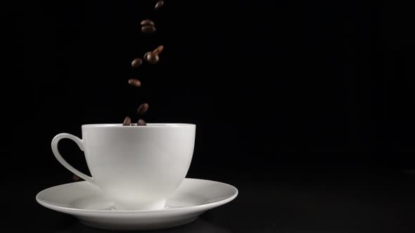 Coffee Beans Falling Into a White Cup