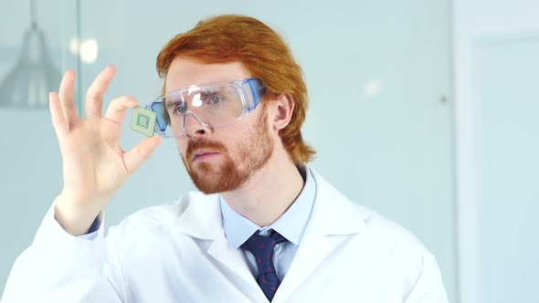 Man in Laboratory Looking on New Electronic Chip