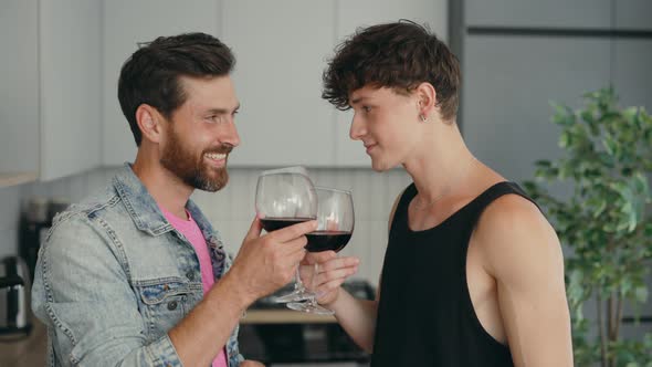 Lgbt Couple Standing in Their New Apartment Drinking Wine From the Glasses Feeling Happy and in Love