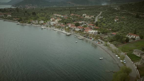 Aerial view of coastal road above town in Greece.