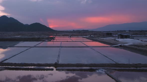 Beautiful reflection of clouds and sky in the stagnant water of natural salt fields at Phan Rang, Vi