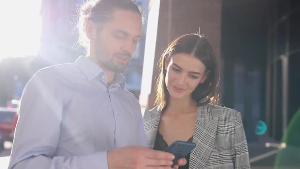 People, Technology. Business Man And Woman Using Phone Outdoors