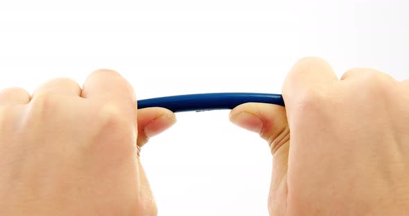 Hands breaking pencil in half on white background