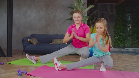 Sporty Mom and Daughter Doing Workout for Legs at Home