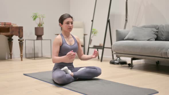 Indian Woman Meditating on Yoga Mat at Home