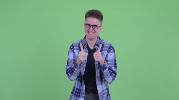 Happy Young Handsome Hipster Man Giving Thumbs Up and Looking Excited