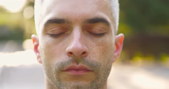 Man Mediatating with Closed Eyes Outdoor on Sunny Day