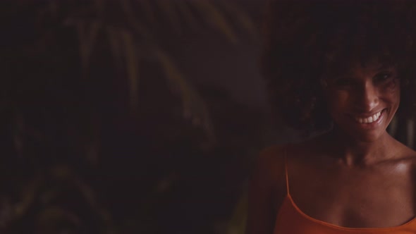 Young Smiling Women With Afro Dancing In Orange Dress