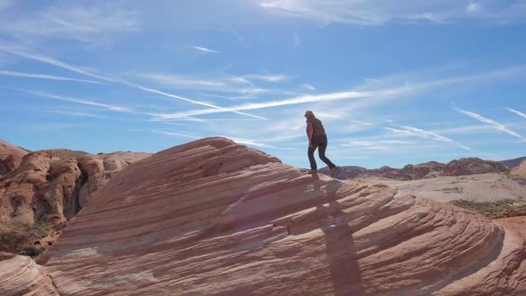 Sports Hiking Woman Climbs Up The Red Rock Background The Sky Slow Motion 