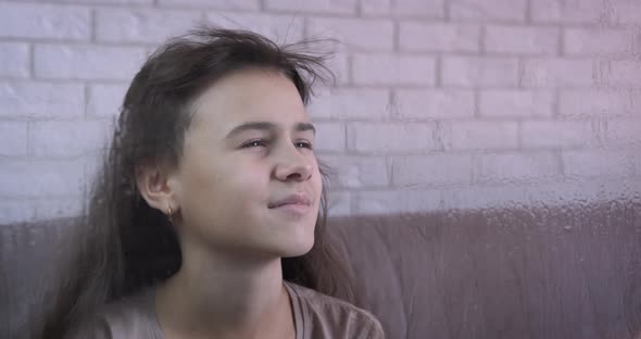 Teen drying her hair. 