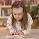 Focused Little Girl Reading Book at Home - VideoHive Item for Sale