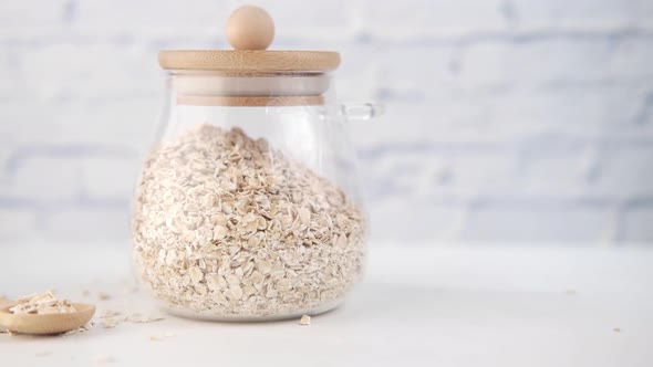 Oats Flakes in a Jar with Spoon on Table