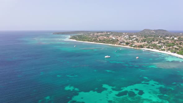 Serene Seascape With Boats Sailing At Playa La Ensenada In The Dominican Republic. Aerial Wide Shot