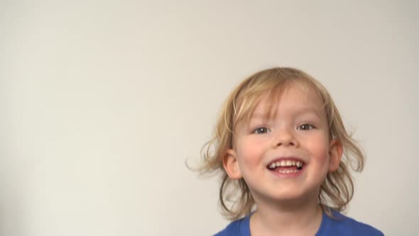 Closeup Face of Charming Little Blond Boy with Blue Eyes