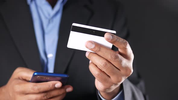 Hand Holding Credit Card and Smart Phone Shopping Online