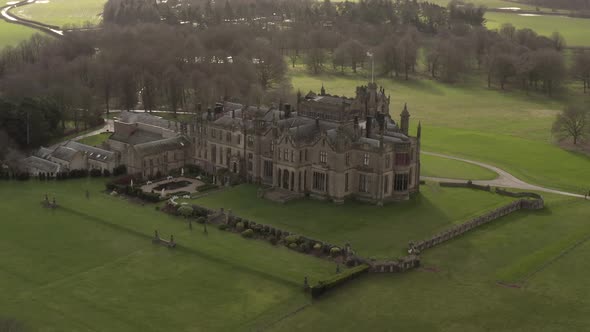 parallax drone shot of castle mansion on sunny day