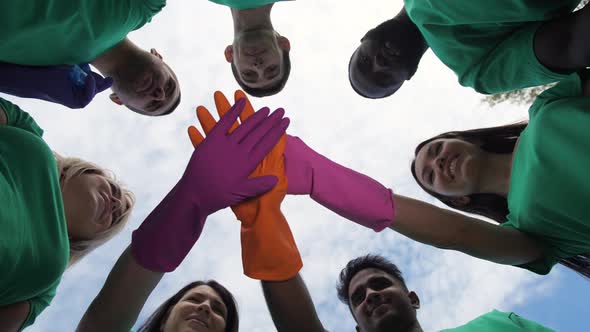 Diverse Group of Cheerful Volunteers Joining Hands