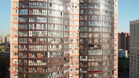 Flying Up Along Modern High Rise Residential Building with Sunny Rays