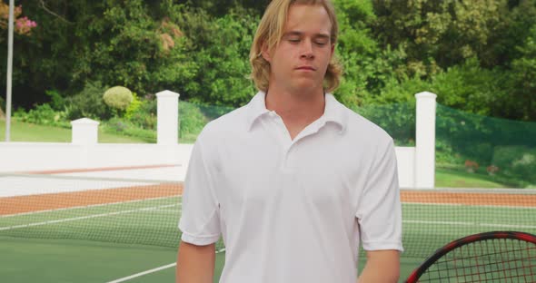 Tennis player rotating his racket