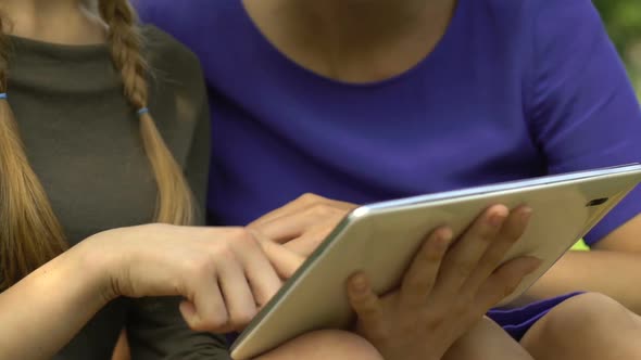 Daughter Showing Mother Mobile Application on Modern Tablet, Shopping Online