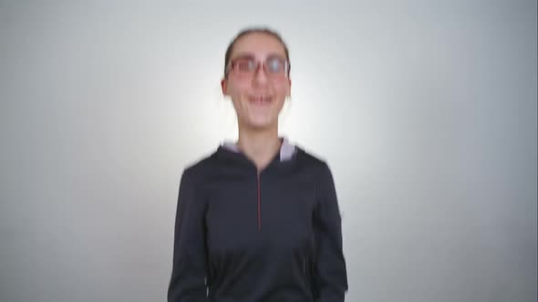 Young Girl in Glasses Jumping with Joy. RAW Video Record