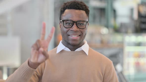 Creative African Man Showing Victory Sign