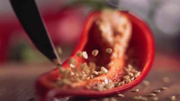 Slow Motion of Grains From Red Chilli Pepper with Knife