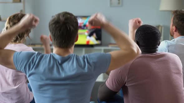 Group of Multiethnic Friends Cheering Football Team, Watching Match on Tv