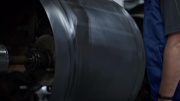 Worker at Tyre Manufacture Controlling Rubber Tape Stamping Process Close Up