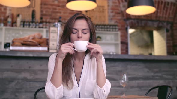 Young girl drinking coffee 