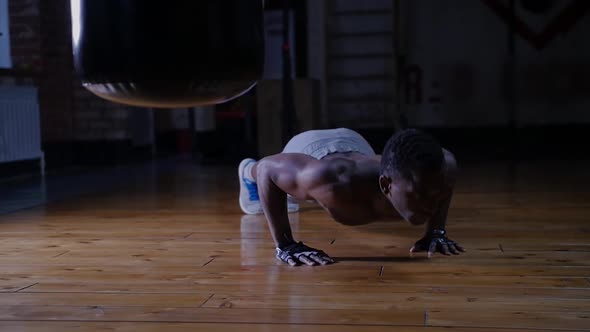 An Africanamerican Handsome Man Training in the Gym  Doing Push Ups