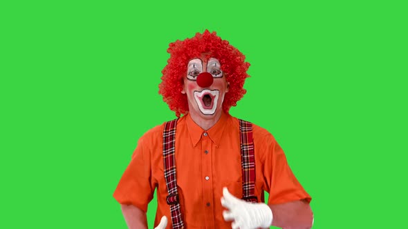 Funny Clown Walking Fast and Making Wait for Me Gesture on a Green Screen Chroma Key