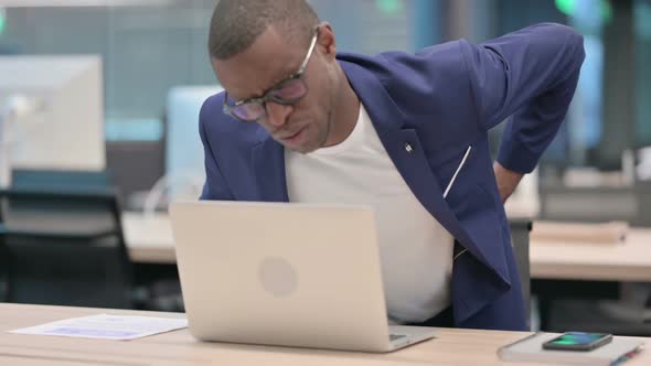 Young African Businessman with Laptop Having Back Pain