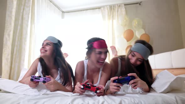 Girls Playing with Video Game with Joystick.
