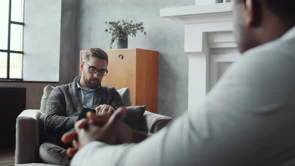 Male Psychologist Listening to Afro-American Man during Counseling Session