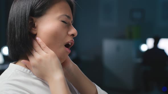 Close Up of AfricanAmerican Businesswoman Suffer From Neck Ache Working Late in Office