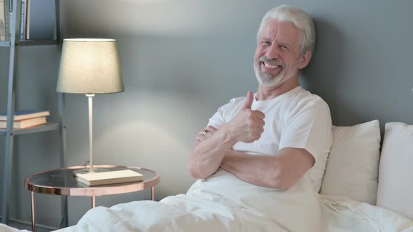 Thumbs Up By Old Man Sitting in Bed, Appreciate 