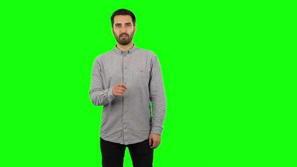 Brunette Guy Is Making Gestures Threatening. Green Screen