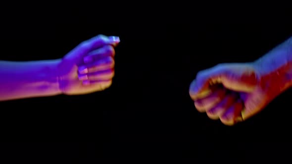 Couple Play Rock Paper Scissors Hand Game on Black Background Under Neon Light