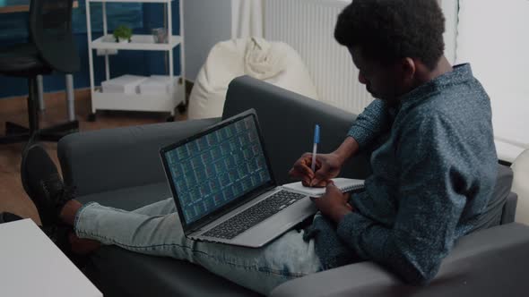 African American Man Analyzing Crypto Currency Stock Markets Trading Checking Stock Ticker Index