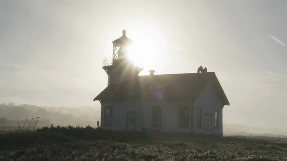 Light House Historic Building with Light Beams Illuminating Cloud at Sunrise USA