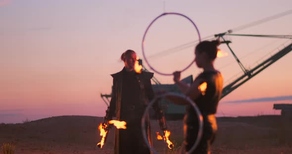 Fire Dancers Against Sunset