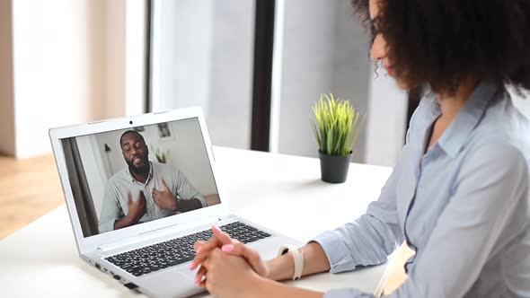 A Young Biracial Woman Is Using a Laptop for Video Connection Indoor