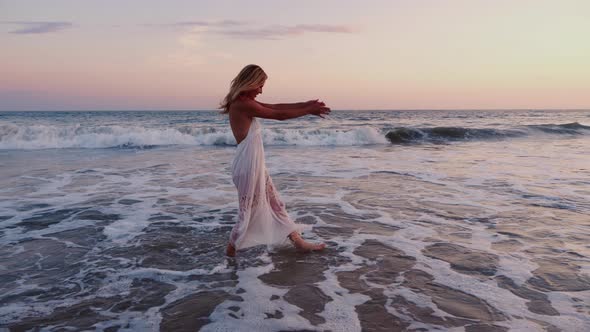 Attractive Woman Enjoying The Beach At Sunset