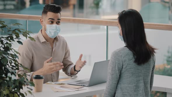 Man Bank Worker Insurance Agent Man in Medical Mask Advises Consulting Girl Woman Client About Loan